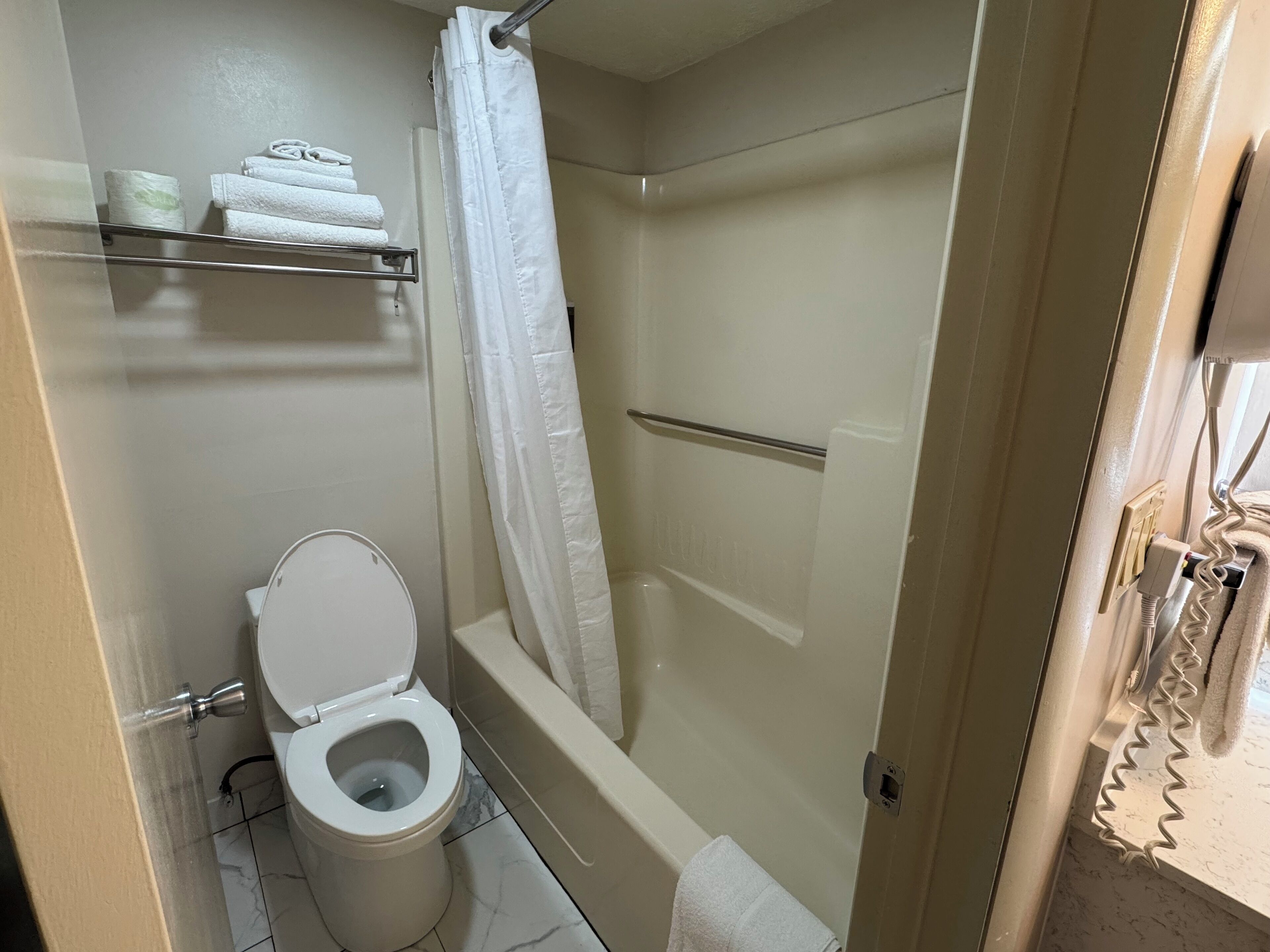 deluxe room, 1 king bed, refrigerator & microwave | bathroom | combined shower/bathtub, eco-friendly toiletries, hair dryer, towels