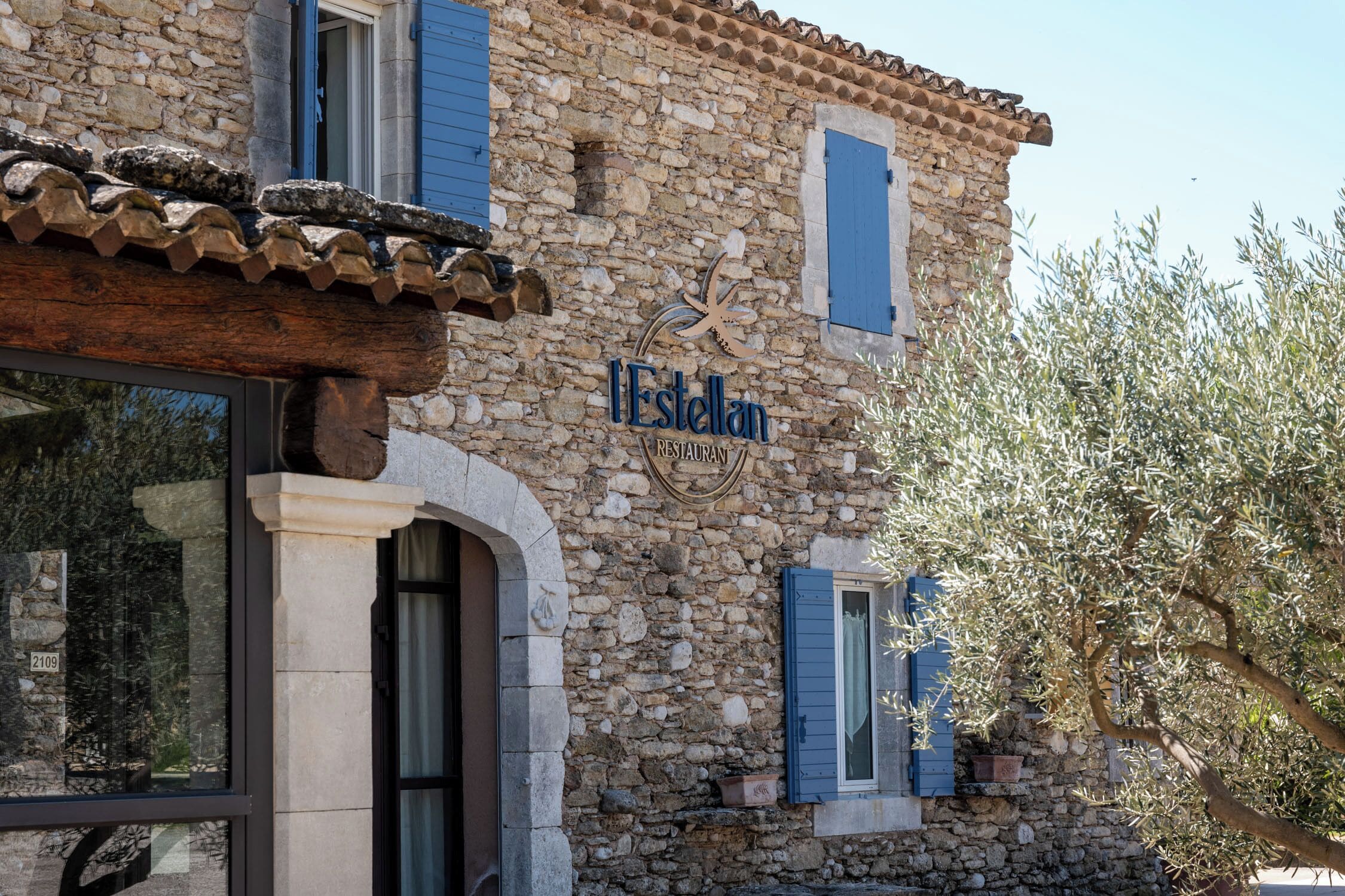 A stone building with a sign reading "Estelan Restaurant".