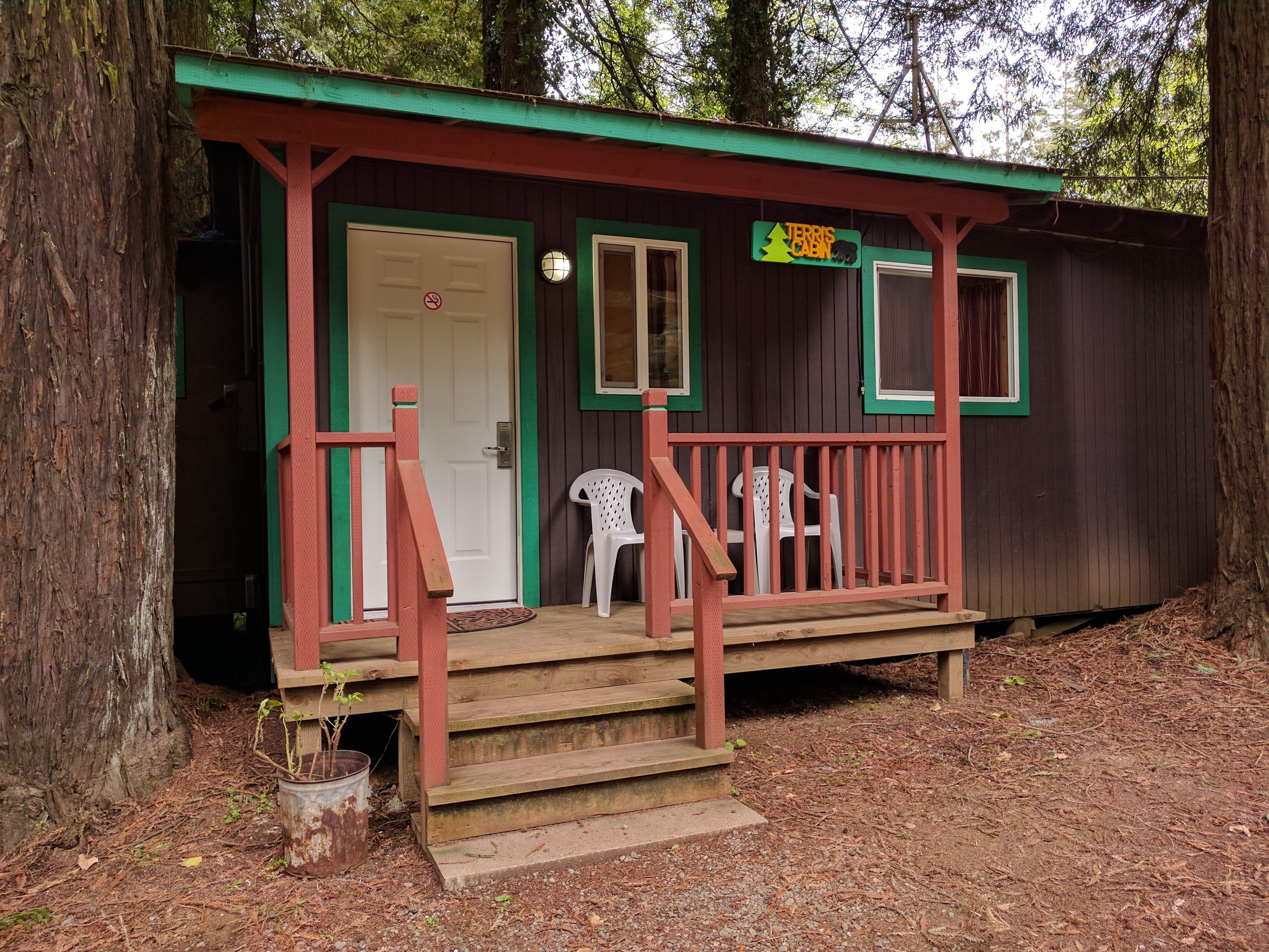 A small cabin with a porch, a door, and a sign that reads "TERRIS CABIN".
