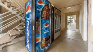 A hallway with a Pepsi vending machine and a staircase. - Rodeway Inn Albany (Albany)