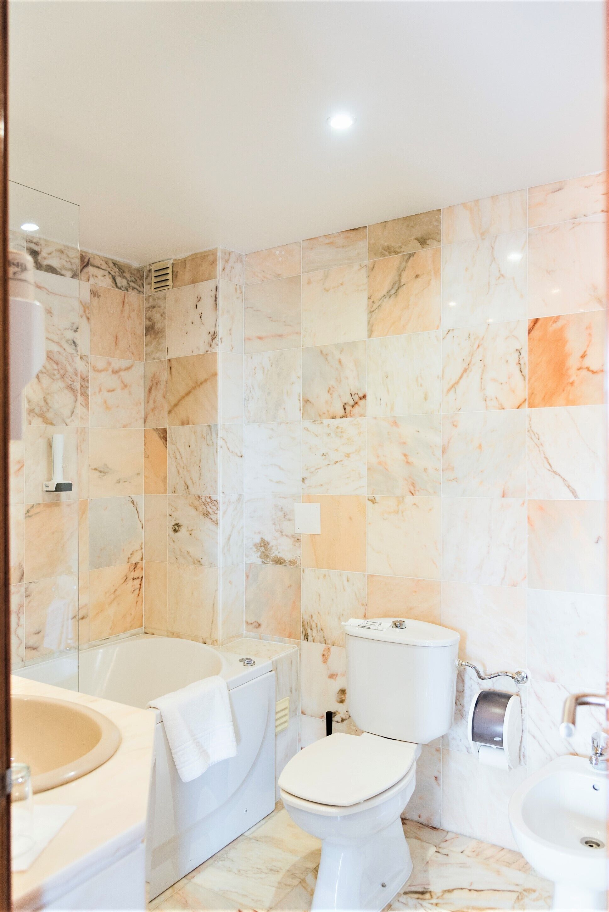A bathroom with a bathtub, toilet, and sink, all in white.