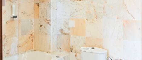 A bathroom with a bathtub, toilet, and sink, all in white.