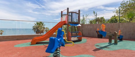 A playground with a slide, swings, and a climbing structure.