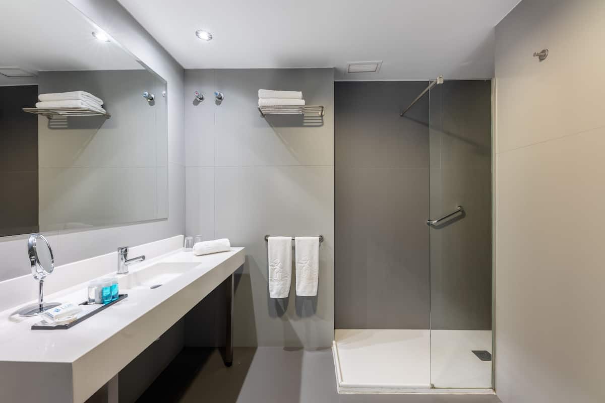 deluxe family room | bathroom | shower, free toiletries, hair dryer, towels