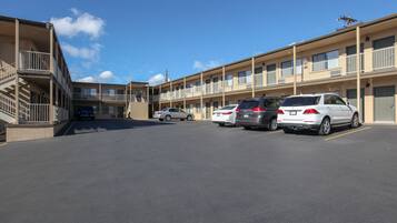 A multi-story motel with a parking lot.