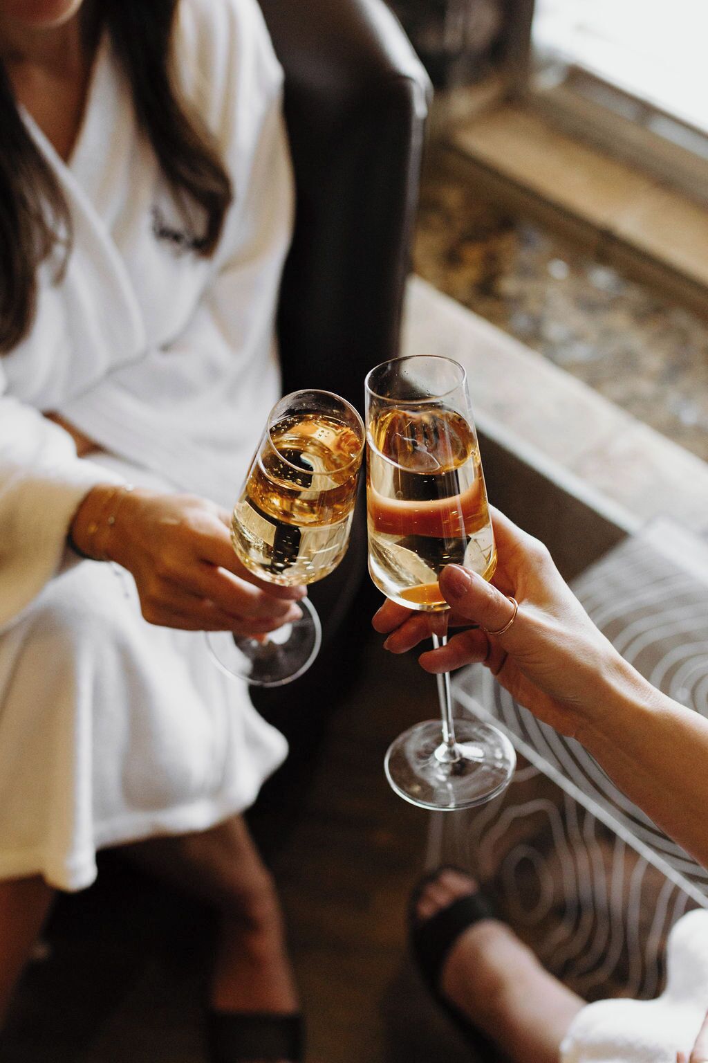 Two people toasting with champagne glasses.