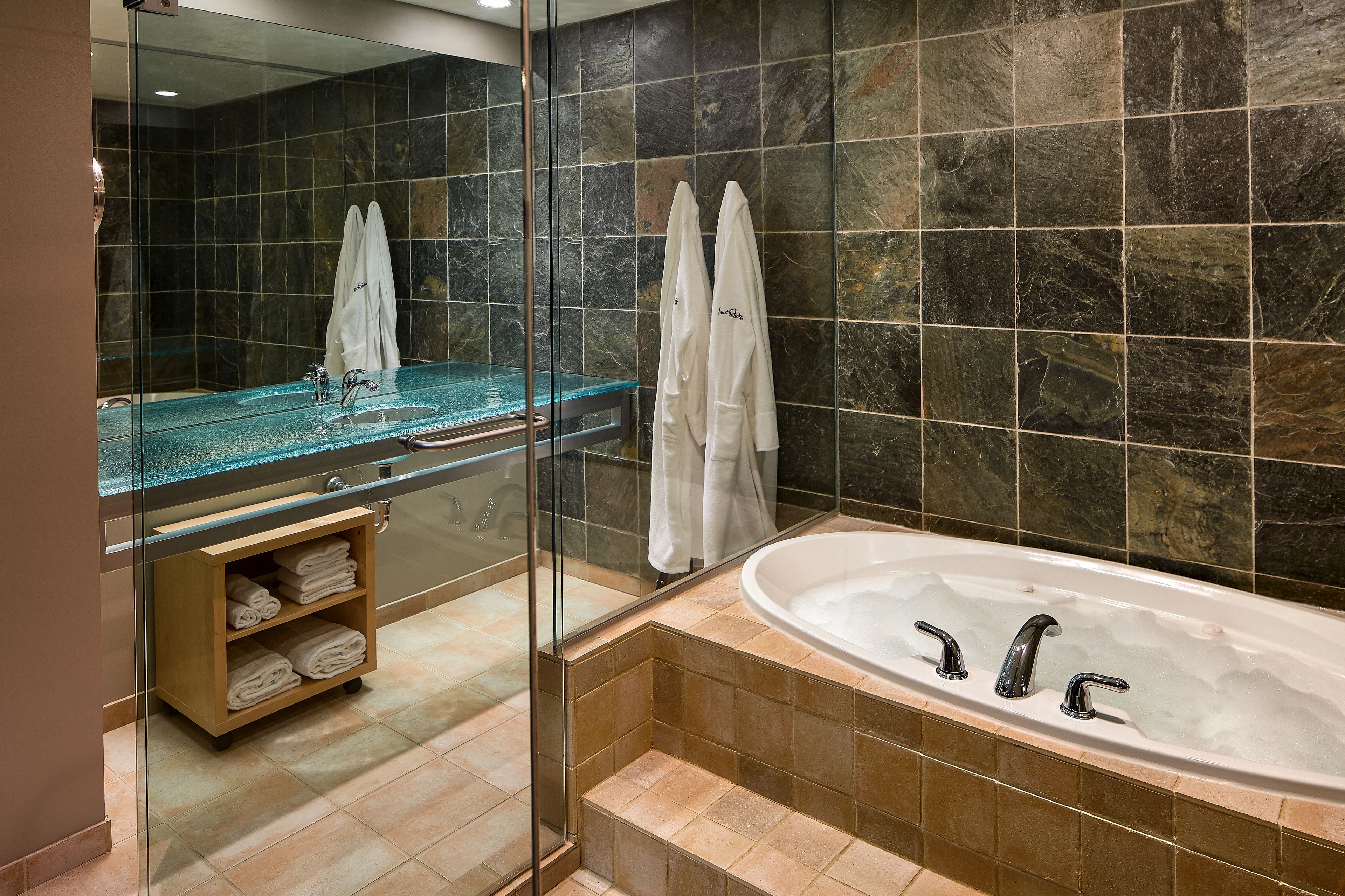 combined shower/bathtub, designer toiletries, hair dryer, bathrobes