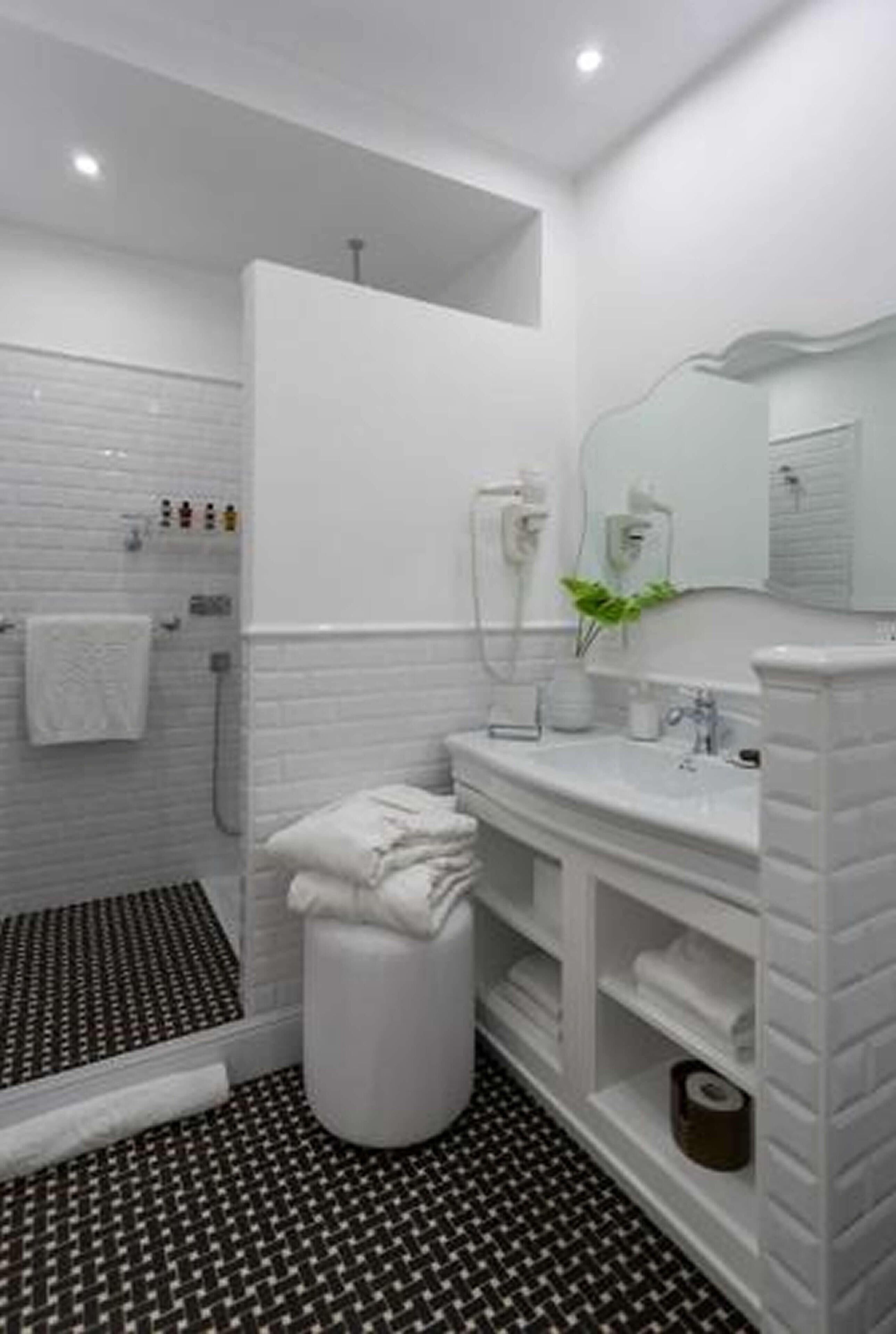 A modern bathroom with a shower, toilet, and sink.