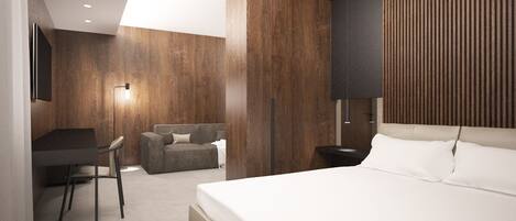 Ein modernes Hotelzimmer mit einem großen Bett, einem Schreibtisch, einer Couch und einem an der Wand befestigten Fernseher.