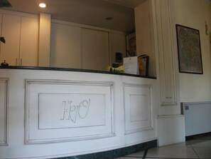 A kitchen with white cabinetry, a marble countertop, and a recessed ceiling light.