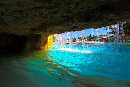 Outdoor pool, pool umbrellas, sun loungers. Travellers Beach Resort