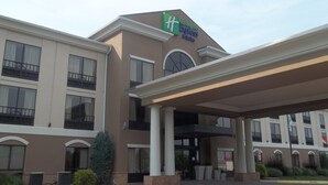 A Holiday Inn Express & Suites building with a covered entrance, large windows, and a fire lane. - Holiday Inn Express Hotel & Suites Winchester by IHG (Winchester)