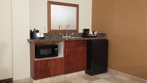 A compact kitchen with a microwave, refrigerator, sink, and coffee maker. - Hampton Inn Oneonta (Oneonta)