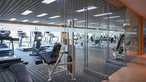 A gym with treadmills, elliptical machines, and weight equipment.
