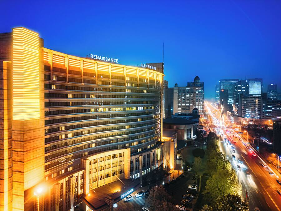 A multi-story hotel with a prominent "Renaissance" sign, surrounded by a busy urban street at night.