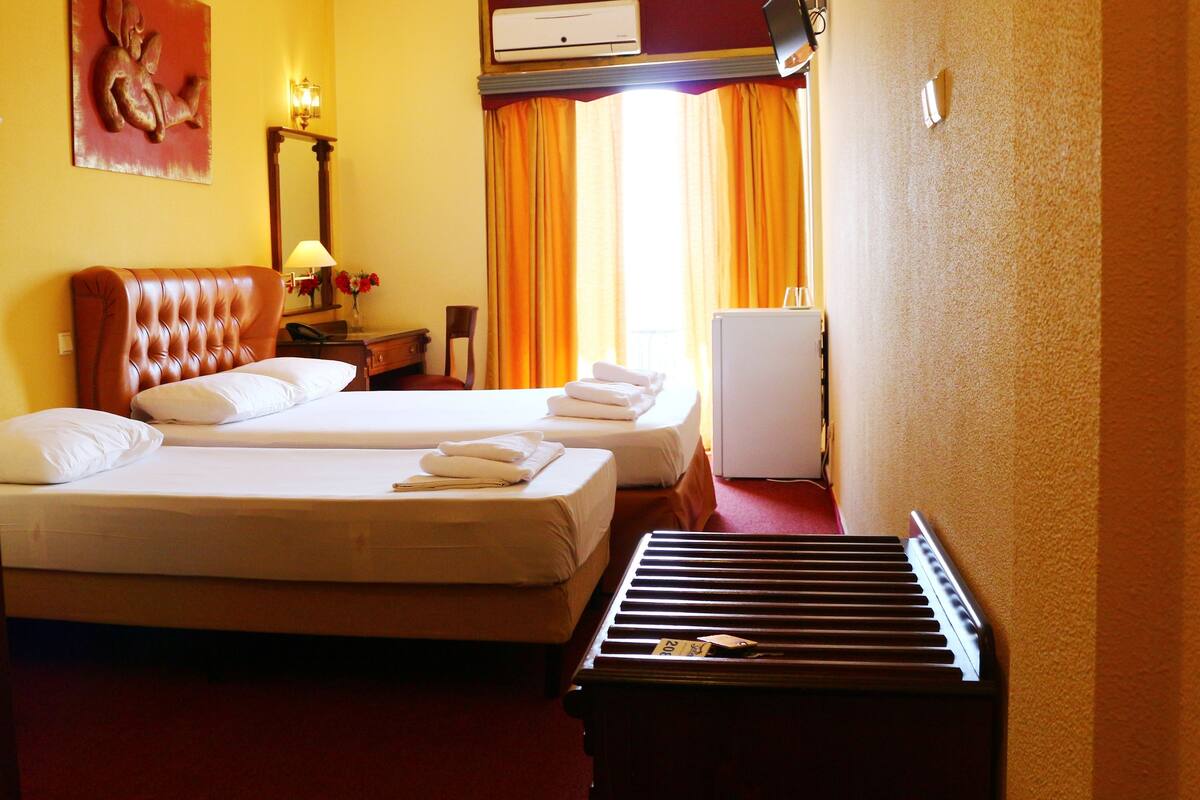 Triple Room | Minibar, desk, laptop workspace, blackout drapes