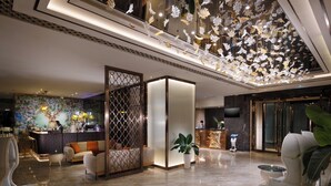 A spacious lobby with a reception desk, seating area, and a decorative ceiling. - Dorsett Wanchai Hong Kong (Hong Kong)