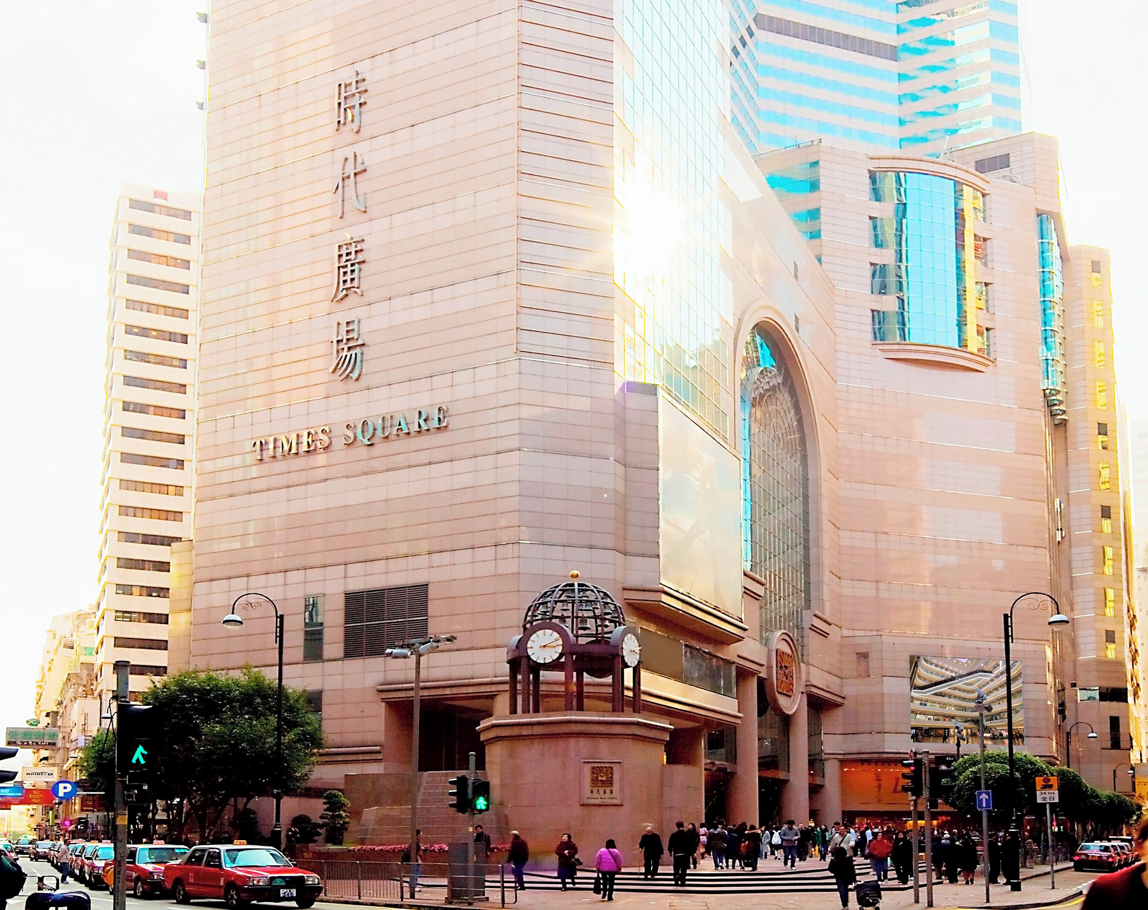 A large building with a prominent clock tower and a sign reading "Times Square".