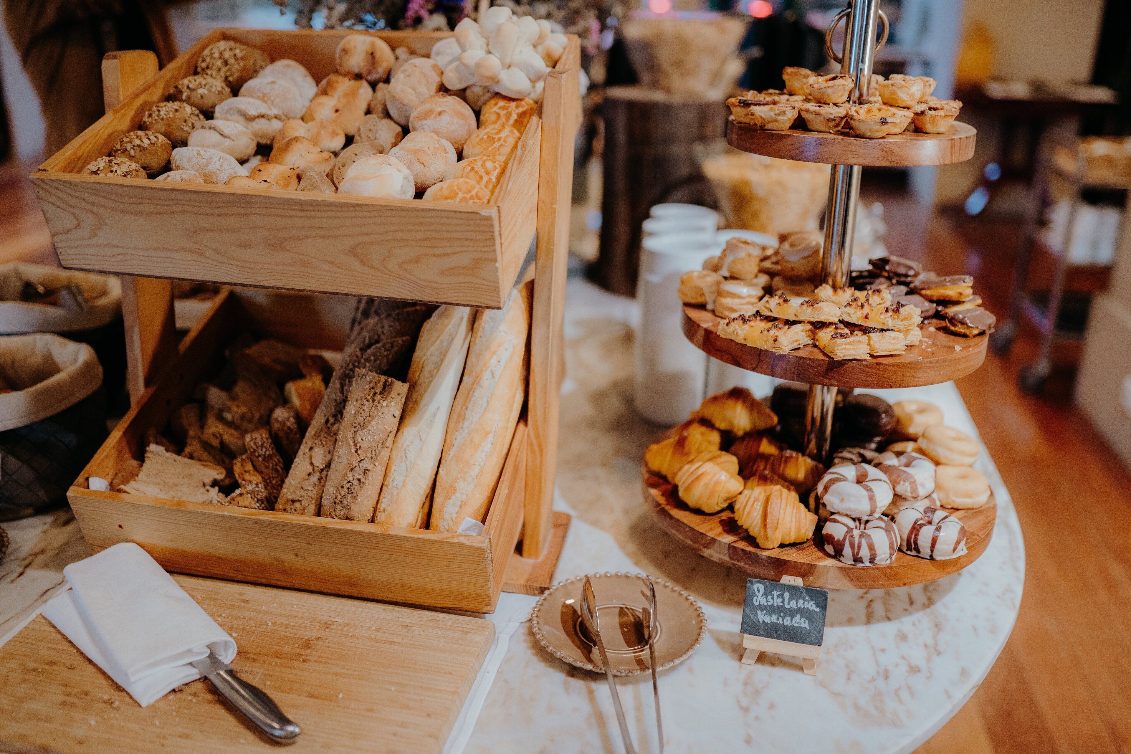 A bakery display with various breads and pastries.