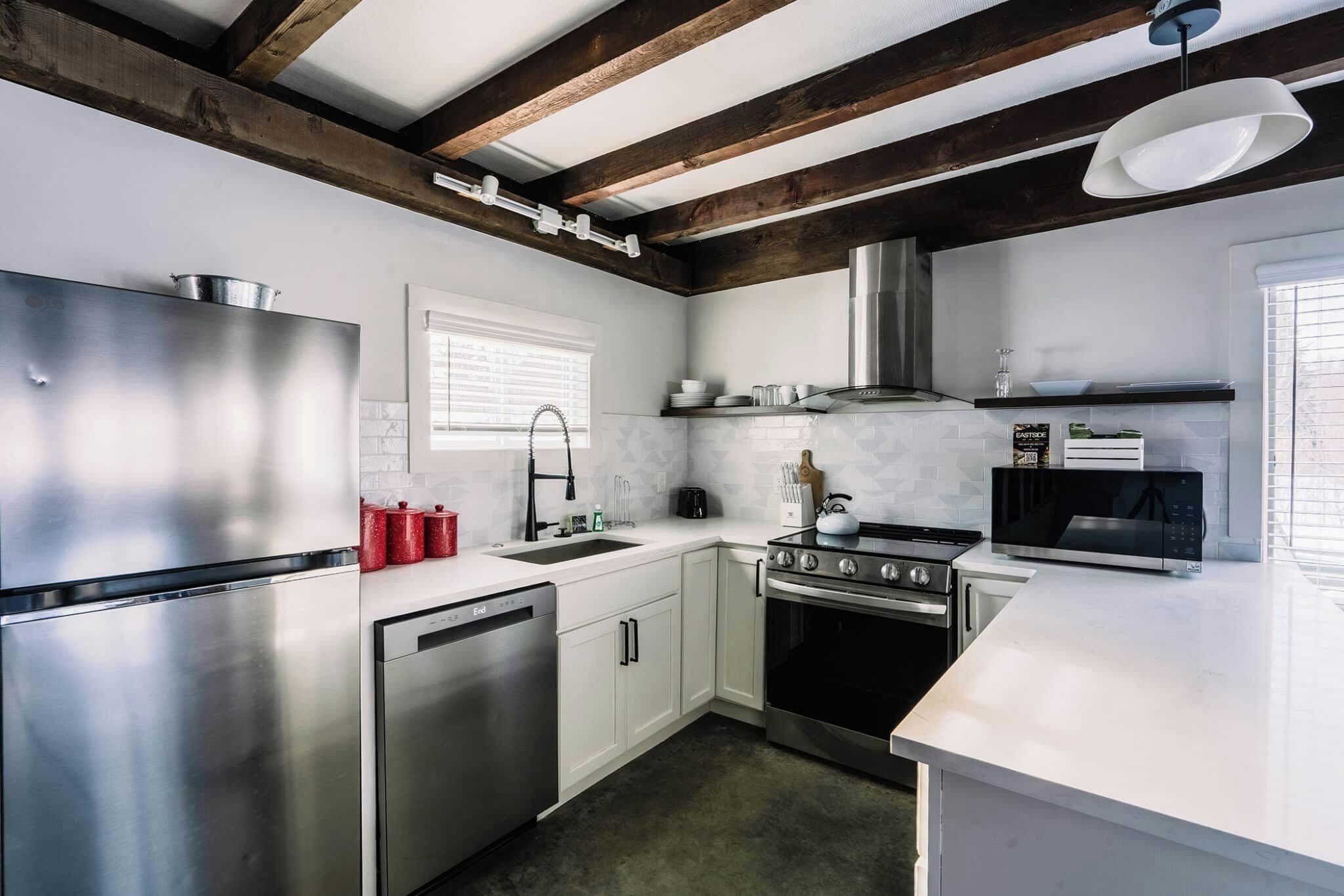 A modern kitchen with stainless steel appliances, a dishwasher, and a stove.