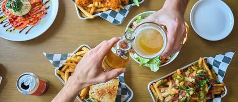 A table with various dishes including a sandwich, fries, and a salad.