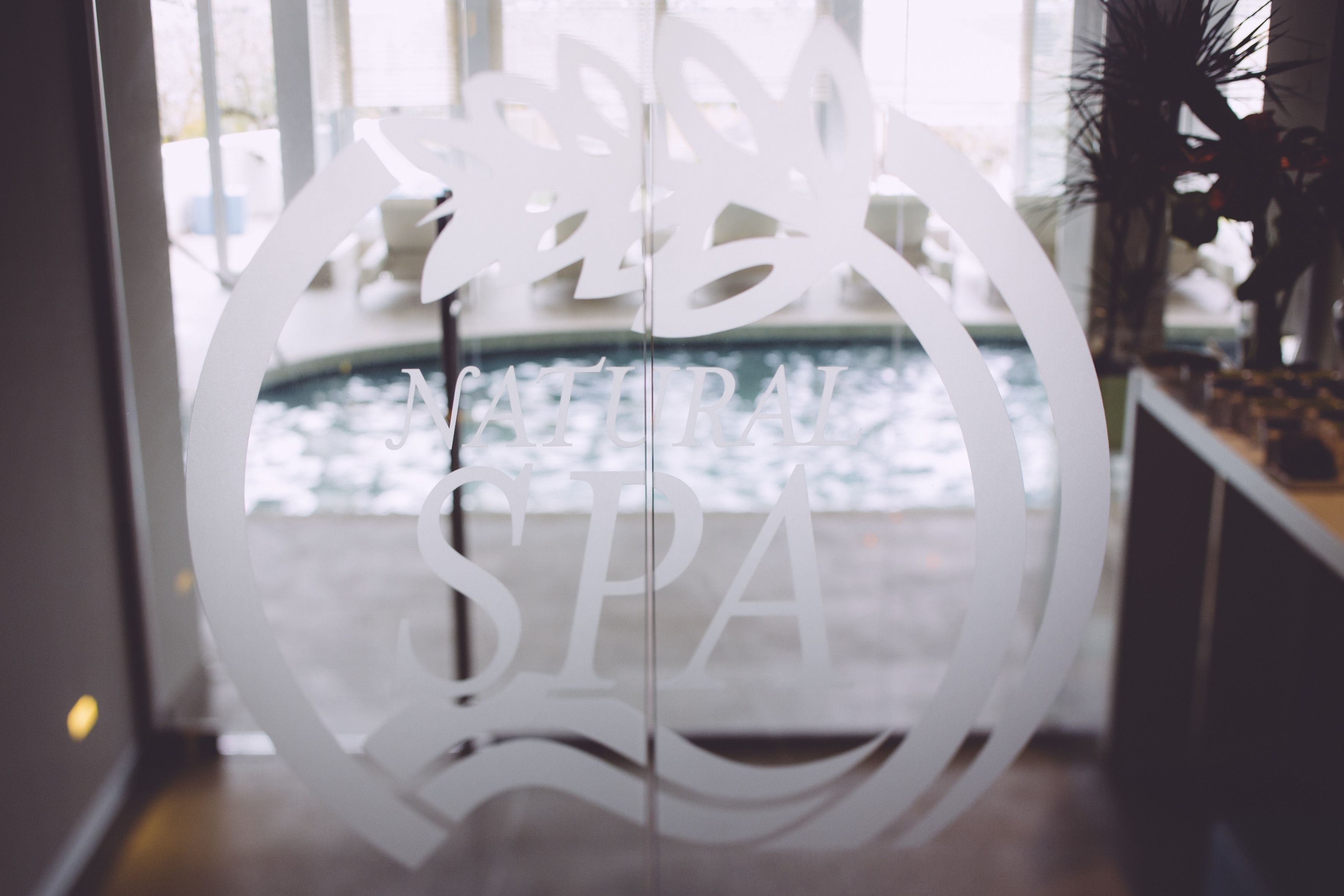 A frosted glass door with the words "SPA" and a stylized wave design.