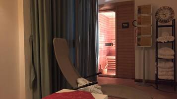 Relax in this serene space with a sauna and comfortable seating area.