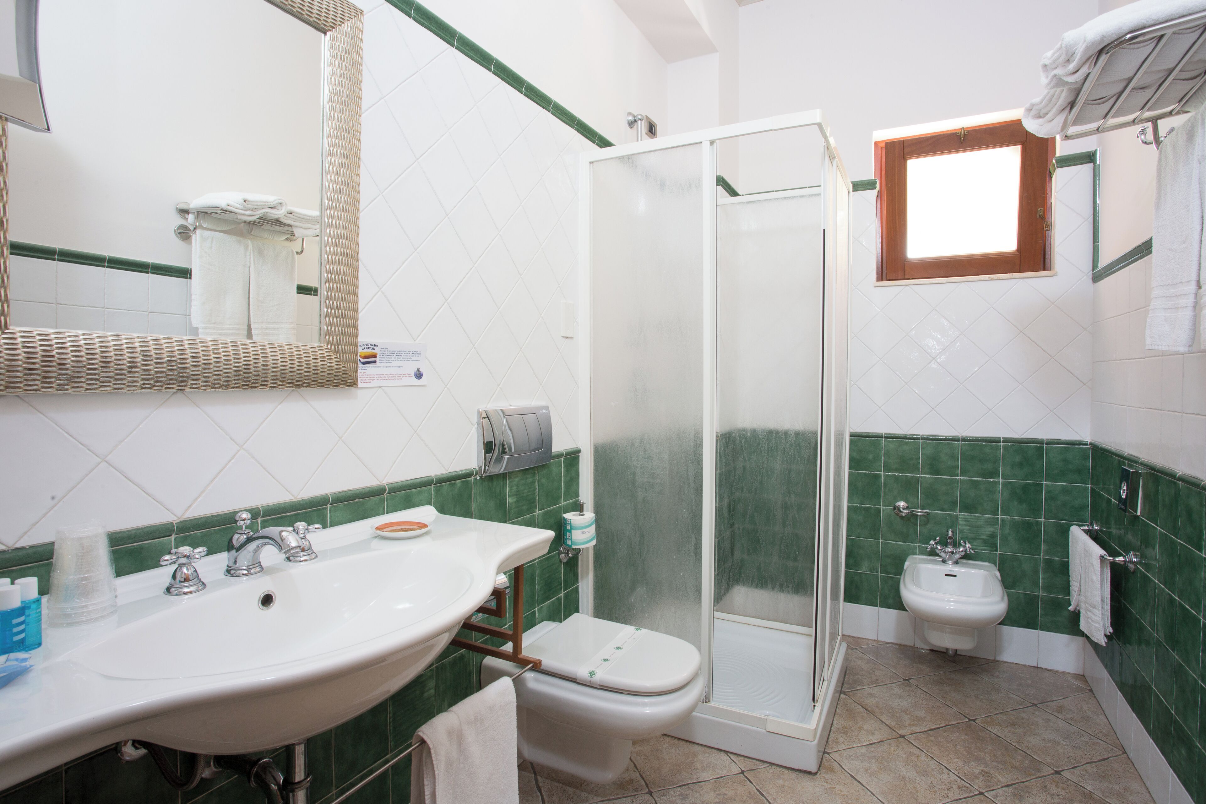 A bathroom with a sink, toilet, and shower.