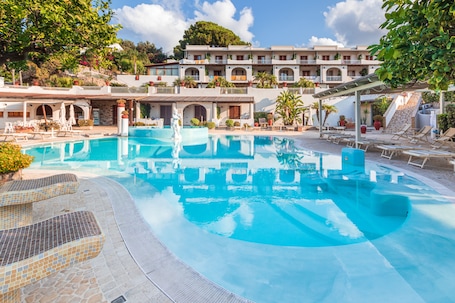 Outdoor pool, sun loungers. Hotel Tritone