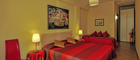 A hotel room with a large bed, two bedside tables, a red chair, and a painting on the wall.