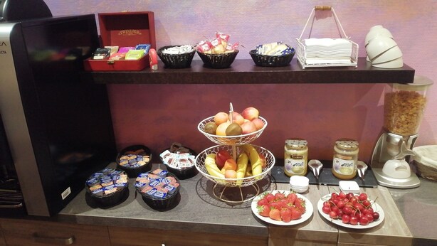 A buffet setup with various food items and condiments. - Hotel d Orléans (Angouleme)