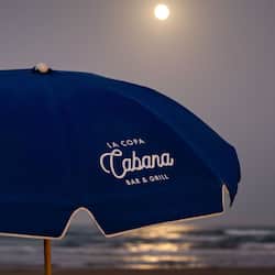 Relax under the shade of a beach umbrella at LA COPA Cabana BAR & GRILL.