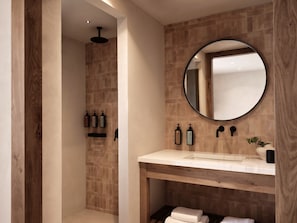 A modern bathroom with a shower, a sink with a mirror, and toiletries. - Stella Blue Seaside Resort (Hersonissos)