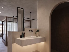 A modern bathroom with a large mirror, a sink, and a shower area. - Stella Blue Seaside Resort (Hersonissos)