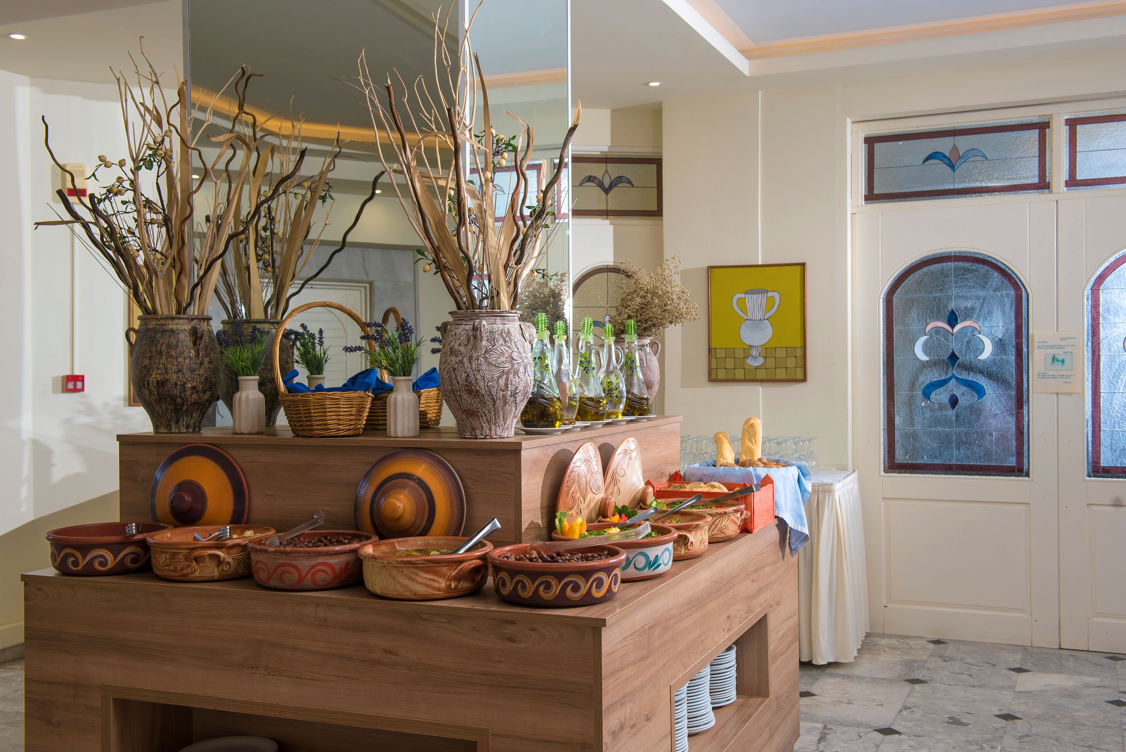 A buffet setup with various dishes and decorative elements.