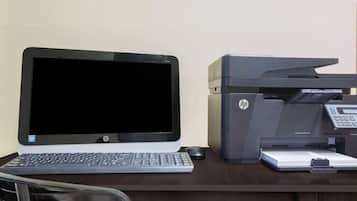 A laptop and an HP printer on a desk.