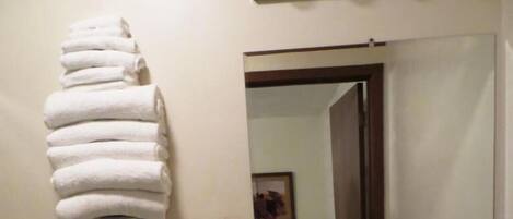 A bathroom with a toilet, sink, and towel rack.