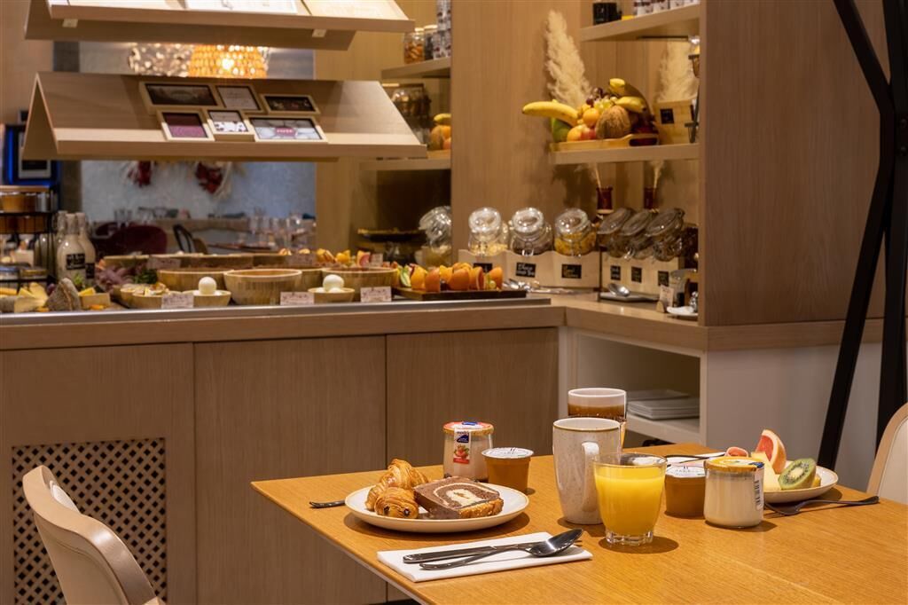 A breakfast buffet with various food items and beverages.