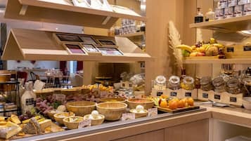 A buffet area with various food items and condiments.