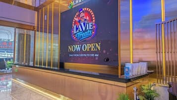 A reception desk with a large sign for 'LAVIE TREATS' indicating it's now open.