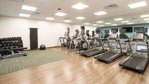 A gym with treadmills, elliptical machines, and weight benches. - Holiday Inn Express Hotel & Suites Auburn by IHG (Auburn)