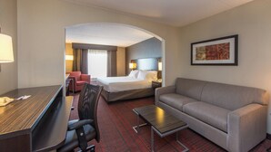 A hotel room with a bed, a sofa, a desk, and a chair. - Holiday Inn Express Hotel & Suites Auburn by IHG (Auburn)