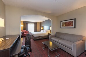 A hotel room with a bed, a sofa, a desk, and a chair. - Holiday Inn Express Hotel & Suites Auburn by IHG (Auburn)