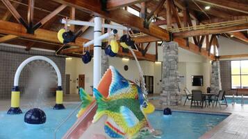 Relax by the pool surrounded by stone pillars and wooden beams, featuring a colorful fish slide and seating area.