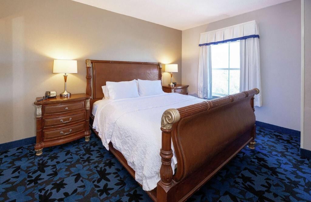 Hypo-allergenic bedding, desk, laptop workspace, blackout drapes