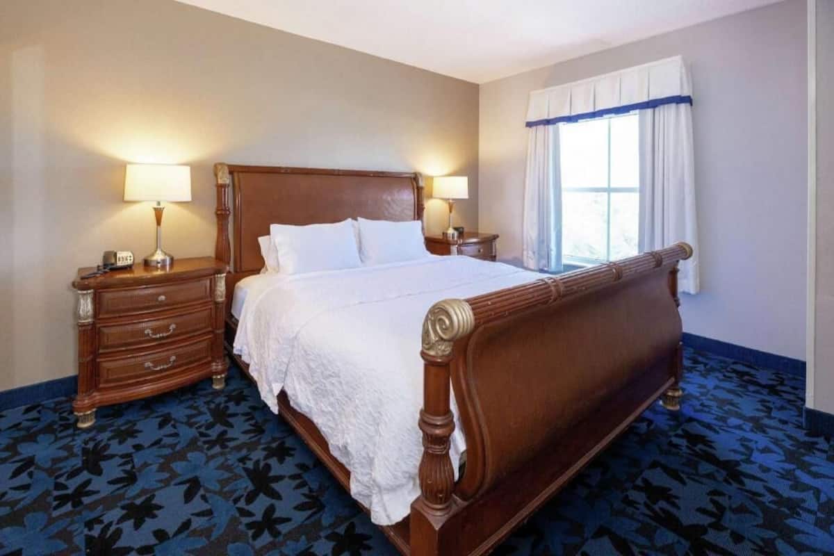 Hypo-allergenic bedding, desk, laptop workspace, blackout drapes