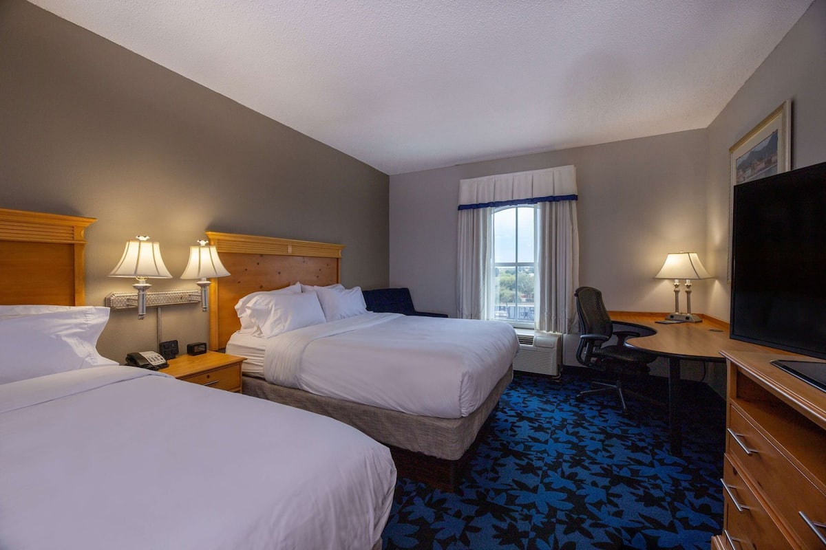 Hypo-allergenic bedding, desk, laptop workspace, blackout drapes