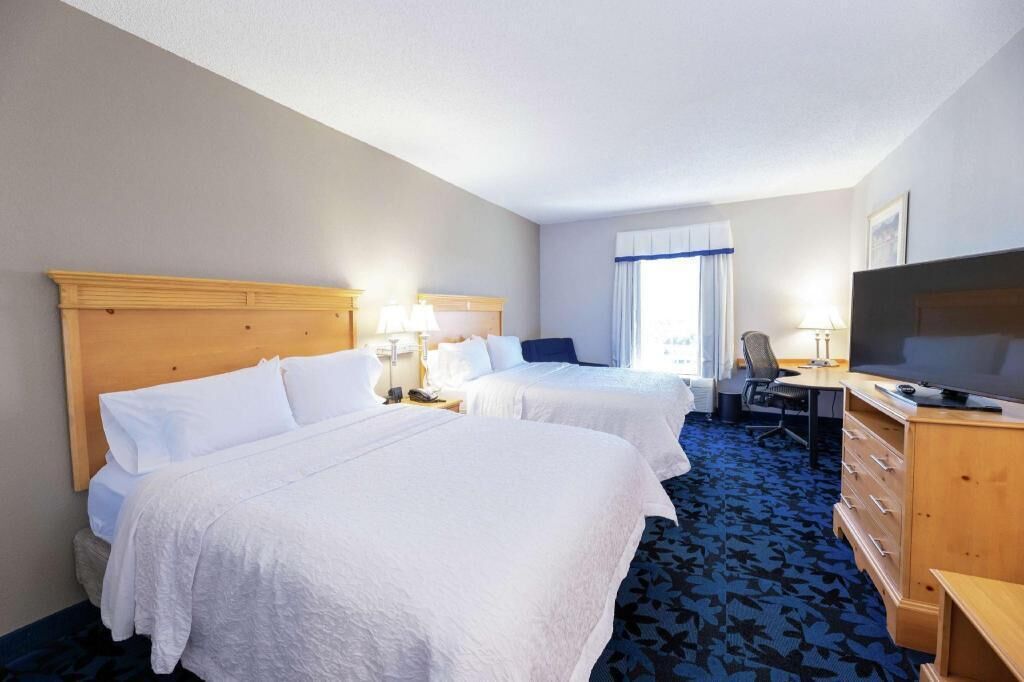 Hypo-allergenic bedding, desk, laptop workspace, blackout drapes