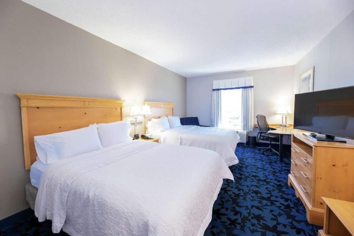 Hypo-allergenic bedding, desk, laptop workspace, blackout drapes