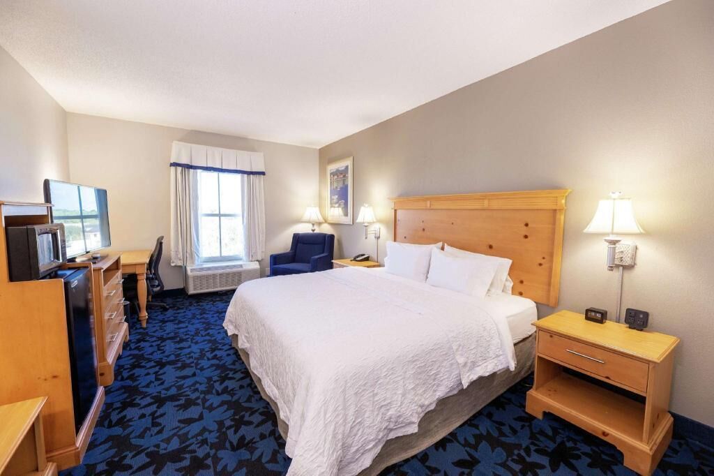 Hypo-allergenic bedding, desk, laptop workspace, blackout drapes